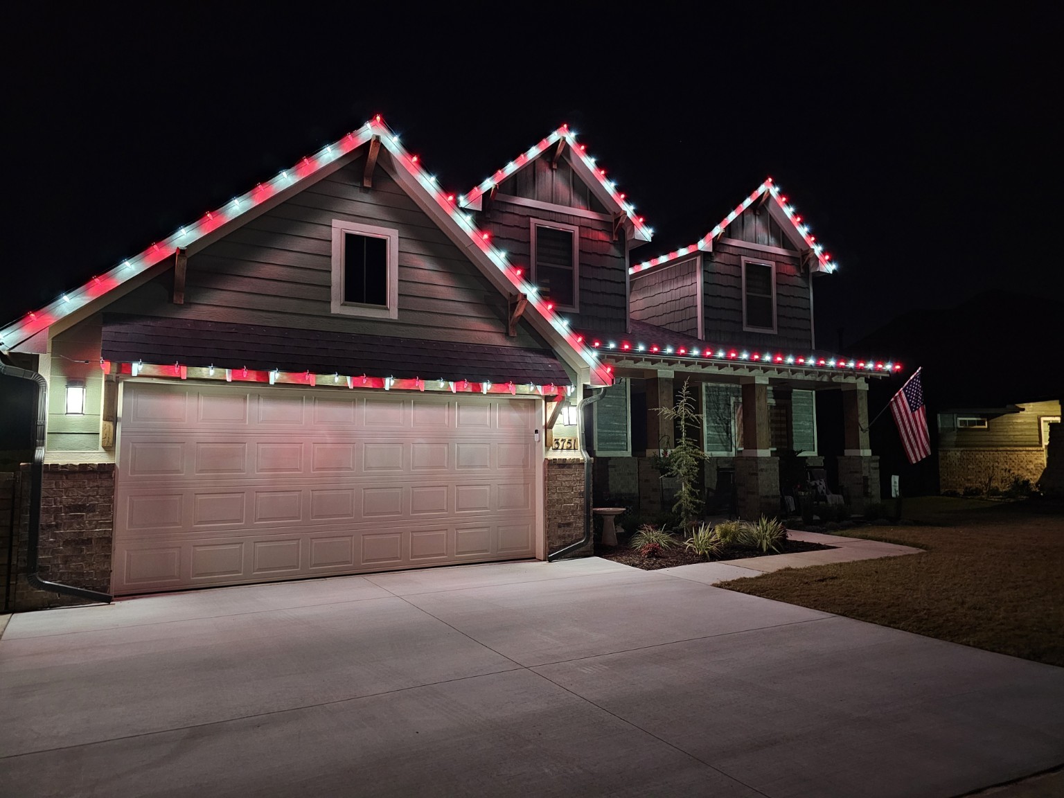 Red-and-white Christmas lights across a home's front roofline