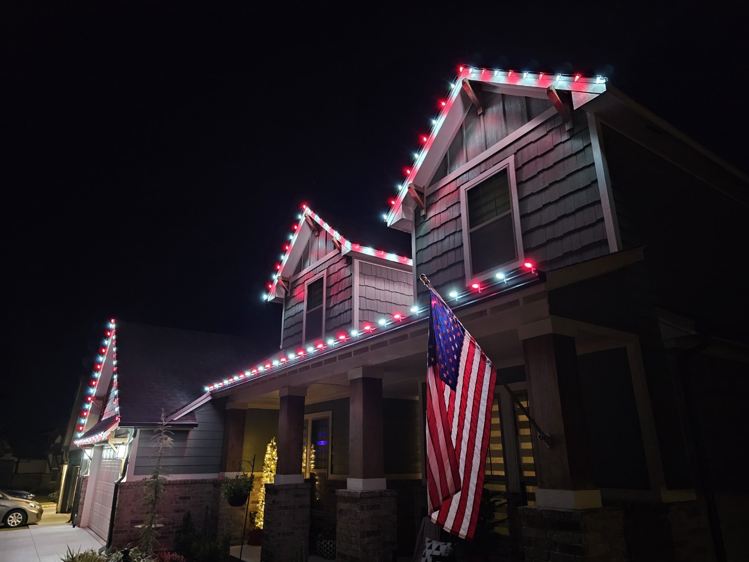 Angled view of red-and-white lights on two-story gables